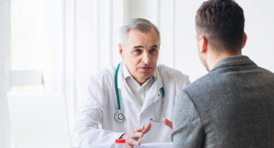 A doctor at a low cost Los Angeles clinic discusses Kaposi's sarcoma with a patient.