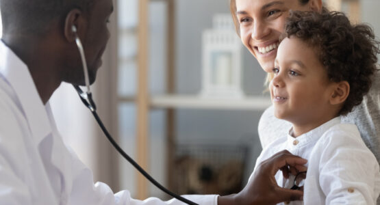 A doctor examines a child's heartbeat.