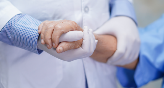 A doctor holding a patient's hand discussing Addison's disease.