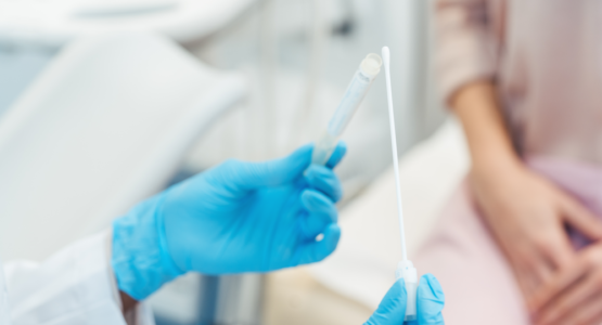 A doctor at a Los Angeles low income clinic holding STD testing tools.