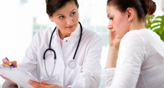 A doctor talking to patient regarding condition.