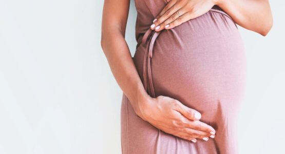 Pregnant women posing with her baby bump