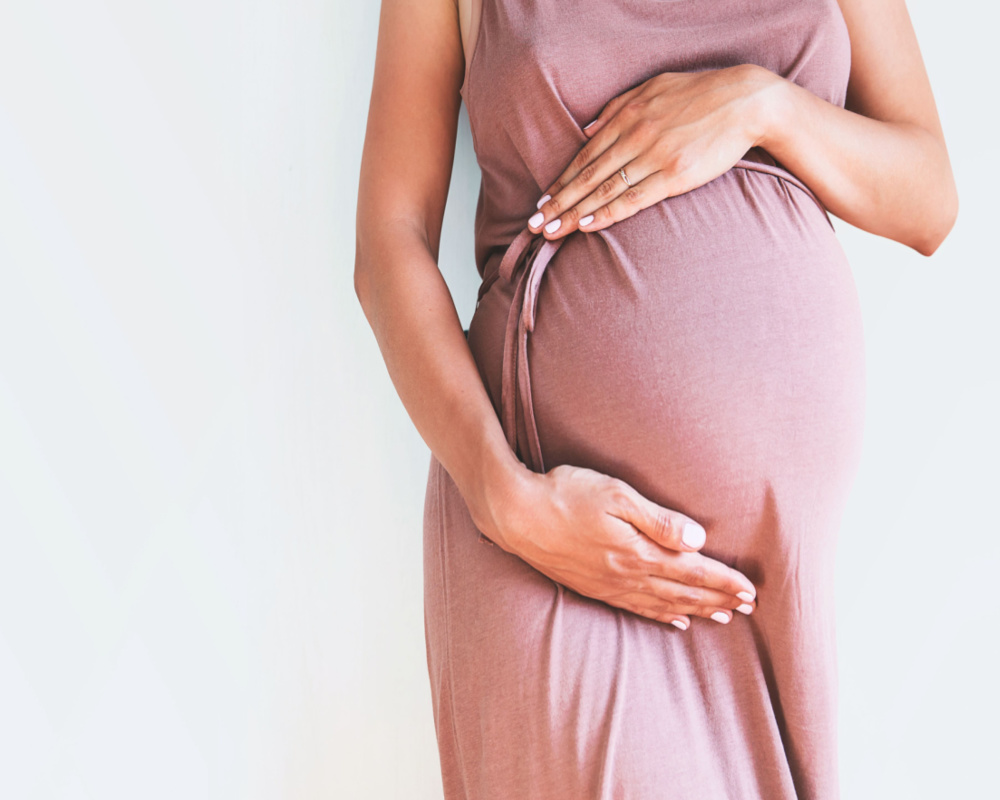 Pregnant women posing with her baby bump