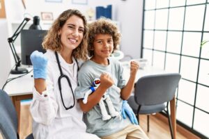 Pediatrician posing with child