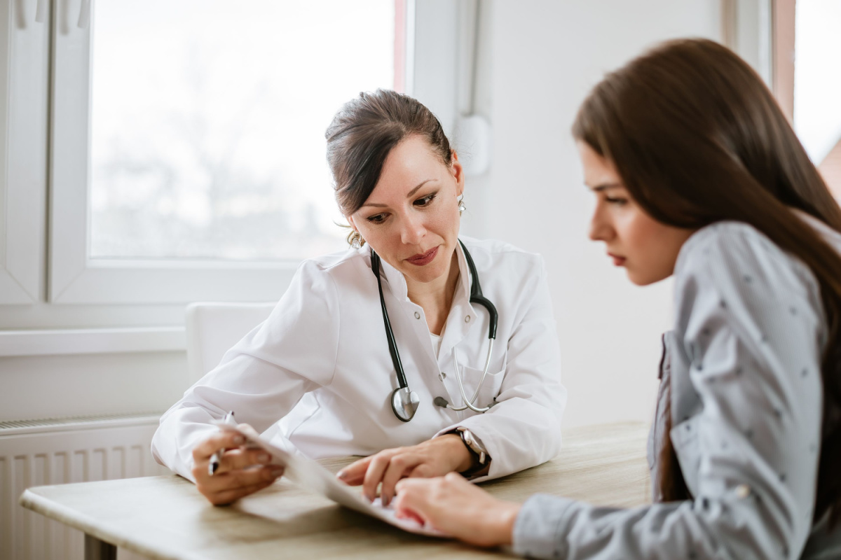 Doctor talking to patient regarding condition.