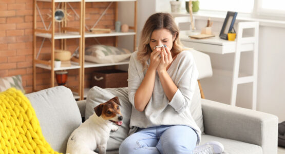 Lady with allergies blowing her nose.