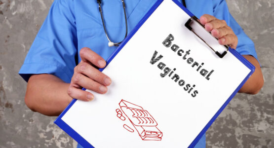 Doctor holding sign saying Vaginal Vaginosis