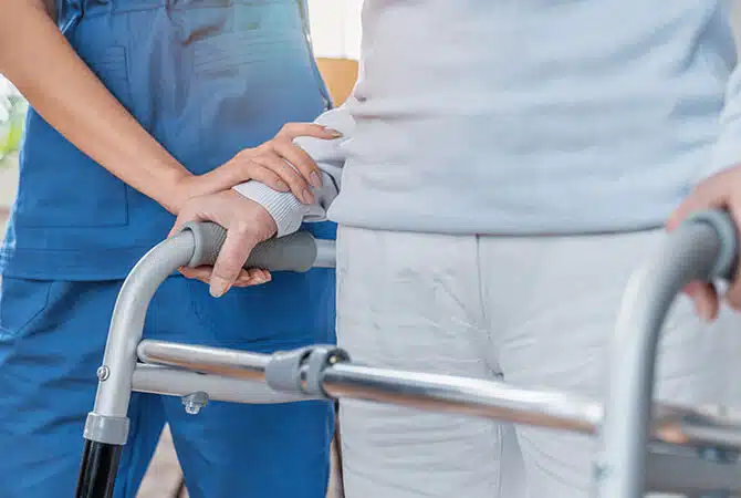 Cropped,Image,Of,Nurse,Helping,Senior,Woman,To,Walk,With