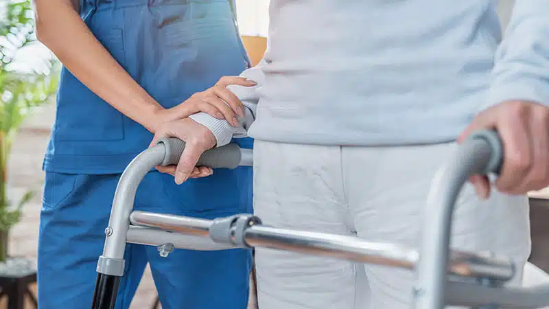 Cropped,Image,Of,Nurse,Helping,Senior,Woman,To,Walk,With