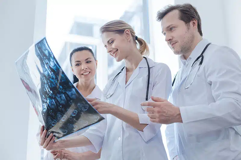 Glad,Oncologists,Discussing,Ct,Scan,Result,In,The,Clinic